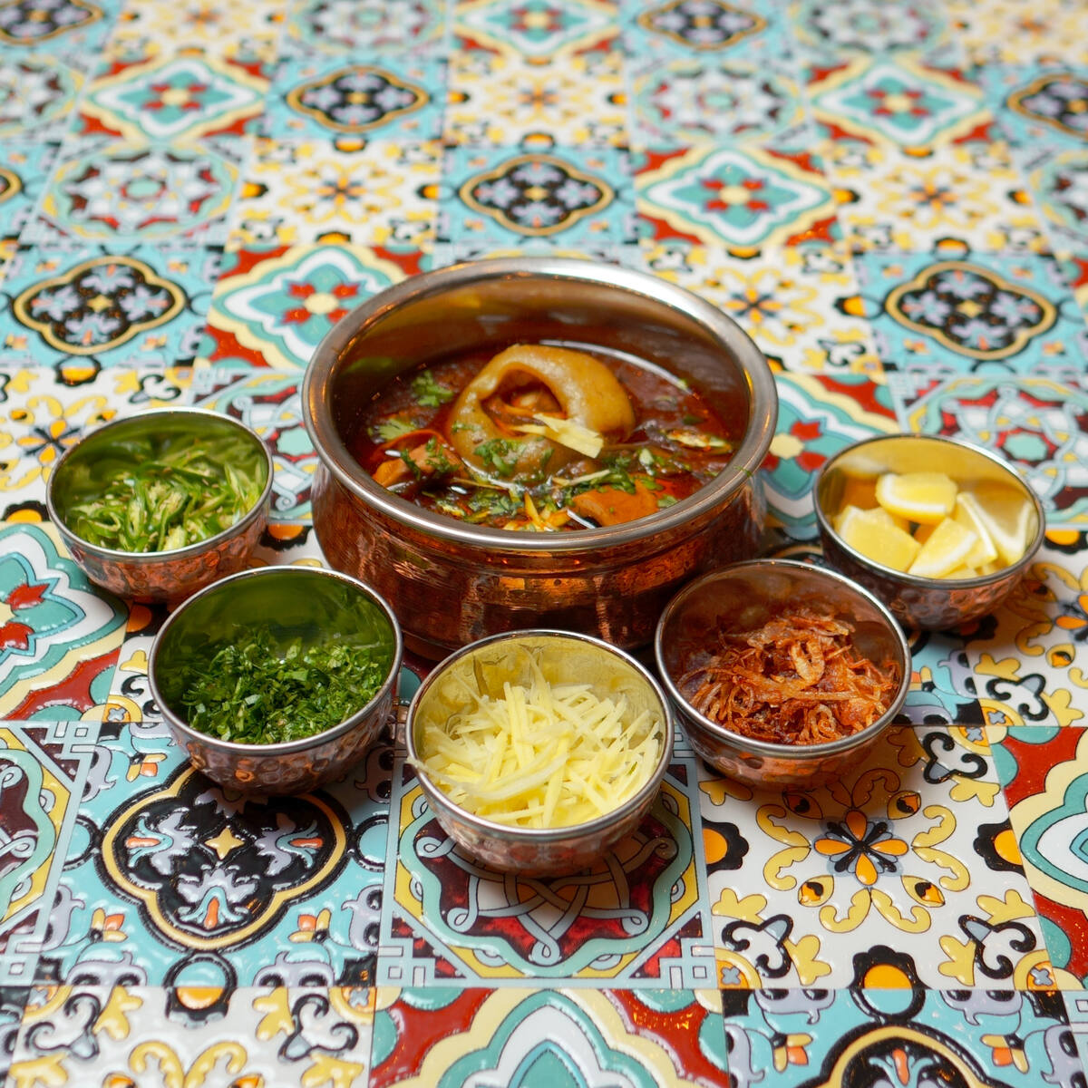 Beef nihari with bone marrow, served with ginger, fried onion, green chilli and lemon at Anarkali Street Food, Ajman